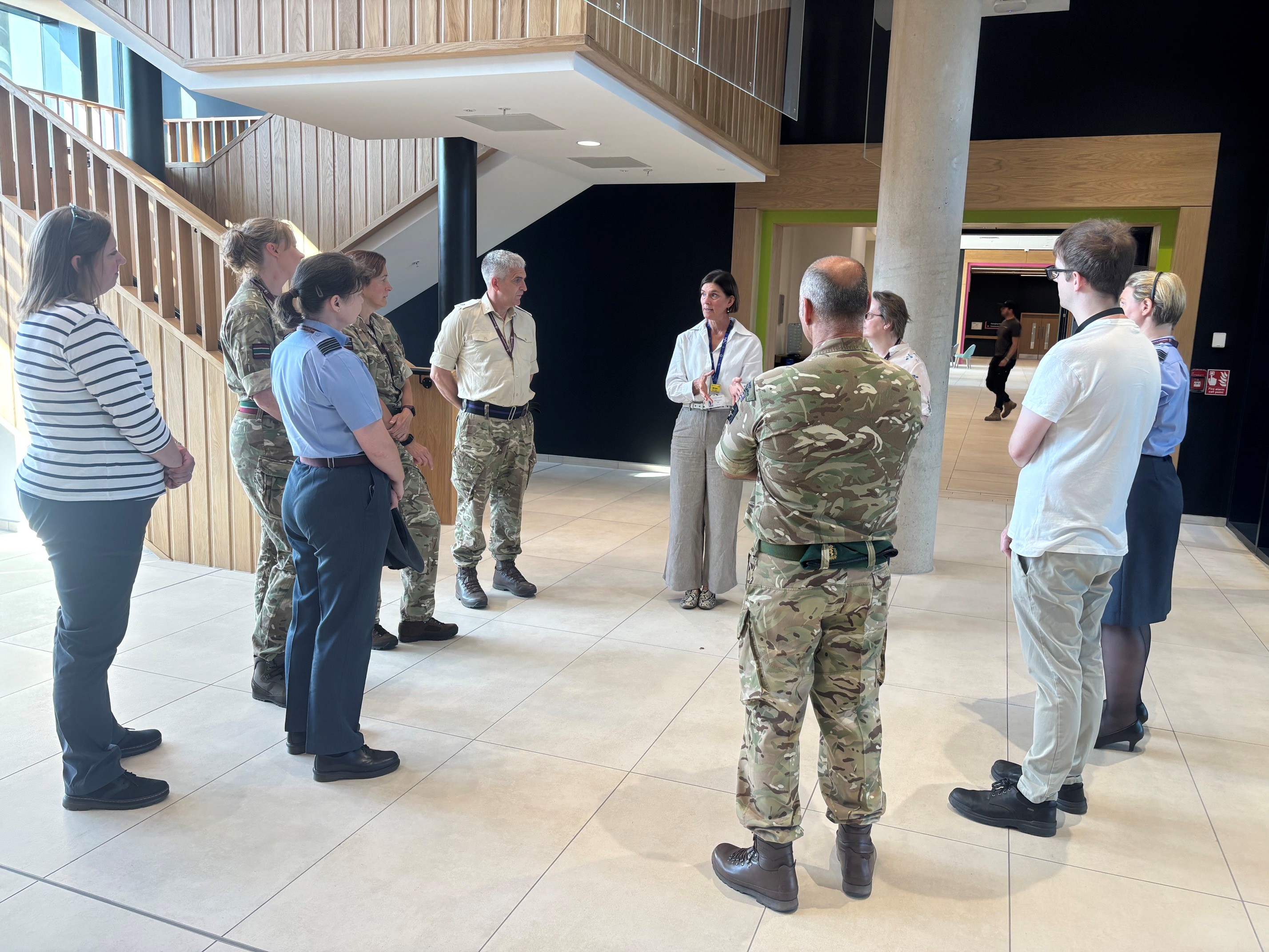 Miriam speaking to a group of military colleagues in the main atrium of the NRC
